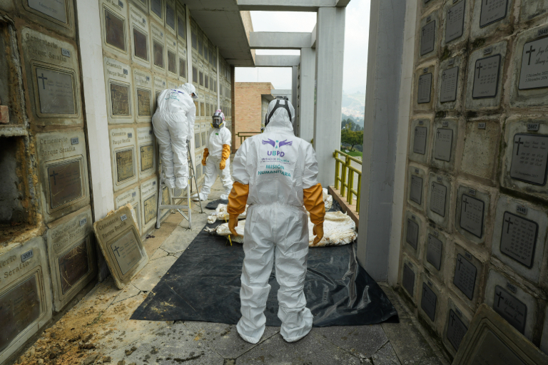 Equipo forense de la Unidad de Búsqueda en una acción humanitaria de recuperación de cuerpos en el cementerio Serafín, en el sur de Bogotá